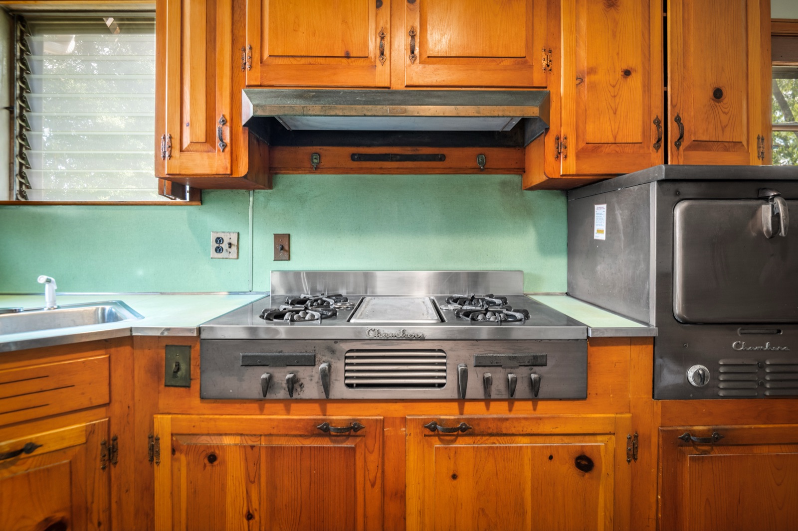 Close-up of the Chambers stainless gas cooktop and matching Chambers wall oven
