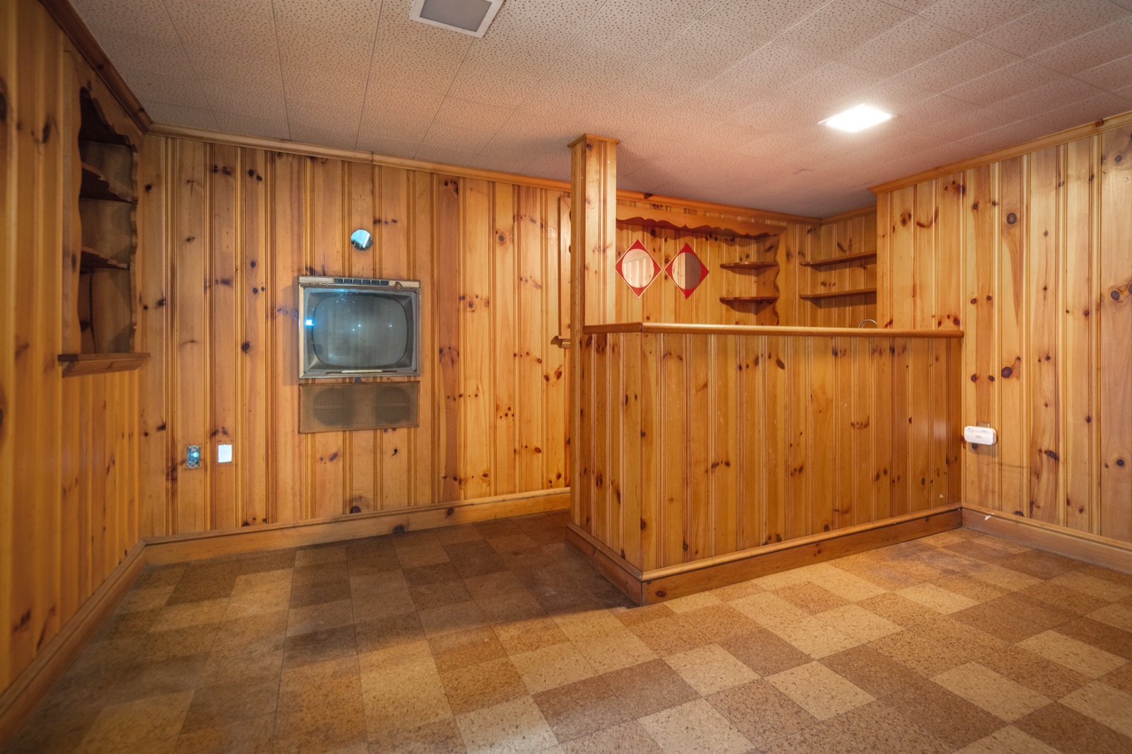The built-in wet bar in the knotty-pine lower level